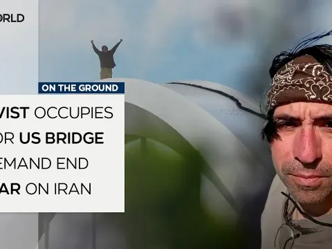 Anti-War Activist Perches on Major US Bridge in Protest Against Iran Conflict
